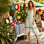 Stylish model in FAFA828 summer outfit at vibrant outdoor market showcasing trendy fashion.